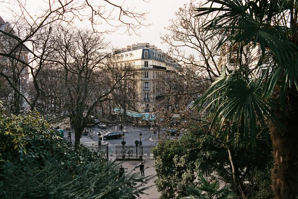 Paris apartment seen through a leafy garden